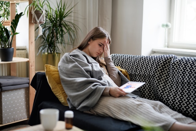 A woman sitting on a sofa at home